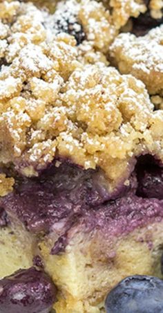 blueberry cobbler with crumbs and powdered sugar on top, ready to be eaten