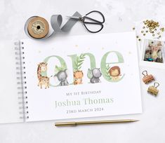 a birthday card with the word one on it, surrounded by other personalized items