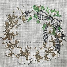 a cross stitched wreath with leaves and bows on the front, in white linen