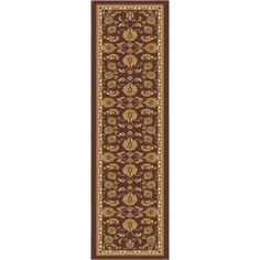 a brown and gold runner rug with an ornate design on the bottom, in front of a