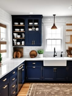 a kitchen with dark blue cabinets and white counter tops, wooden shelves above the sink