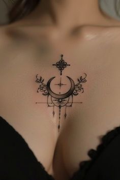 a woman's breast with a crescent and cross tattoo on the side of her chest