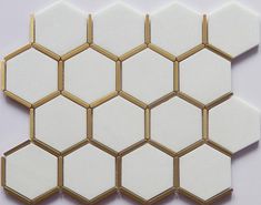 white and gold hexagon tiles on a white surface with golden trimmings