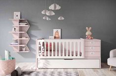 a baby's room with grey walls and pink furniture