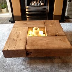 a wooden table with candles in it on carpeted floor next to fire place and fireplace