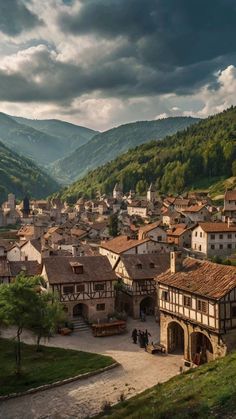 an old village with mountains in the background