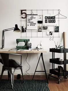 a sewing machine sitting on top of a wooden table next to a black and white chair