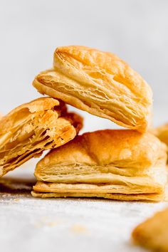 a stack of biscuits sitting on top of each other next to some pieces of bread