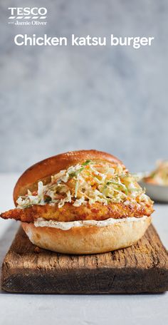 chicken katsu burger sitting on top of a wooden cutting board