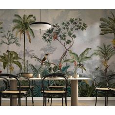 the wallpaper in this dining room is painted with tropical plants and birds on it