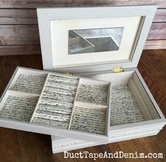 an open box with writing inside sitting on top of a wooden floor