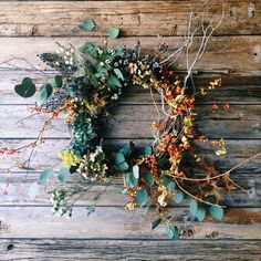 a wreath is hanging on the side of a wooden wall