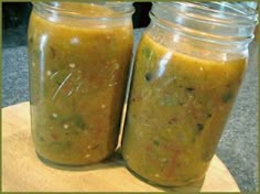 two jars filled with food sitting on top of a table