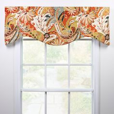 the window is decorated with an orange and white paisley design, along with a matching valance