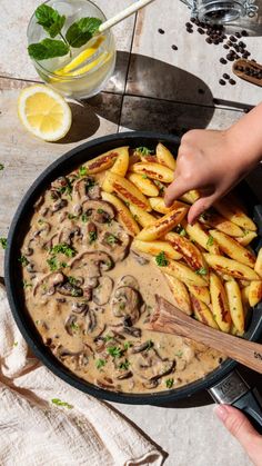 a pan filled with french fries covered in mushroom gravy