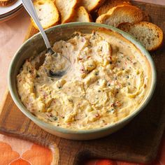 a bowl of dip with bread on the side