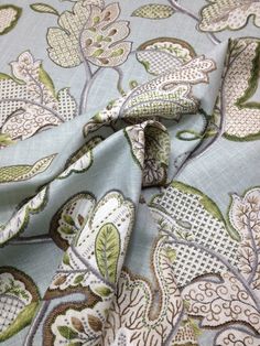 an image of a blue and green fabric with flowers on the bottom half of it