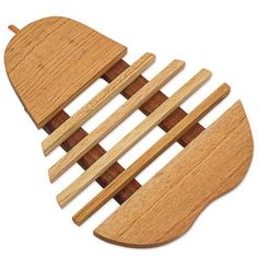 four wooden paddles are arranged in the shape of an airplane on a white background