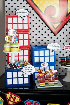 a table topped with lots of desserts and cupcakes on top of it