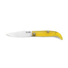 a knife that is sitting on top of a white surface with a black handle and yellow blade