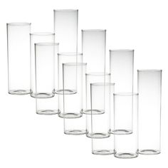 a set of six clear vases sitting next to each other on a white background