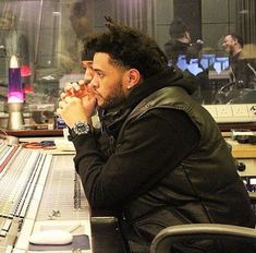 a man sitting in front of a mixing desk