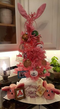 a pink christmas tree decorated with candy and candies in the shape of bunnies