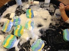 a child playing with soap in a bathtub