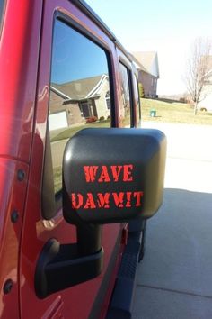 a red truck with the words wave damwt on it's side mirror and door handle