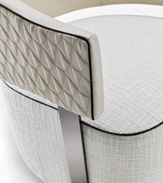 an upholstered chair with a curved back and seat cushion is shown in this image