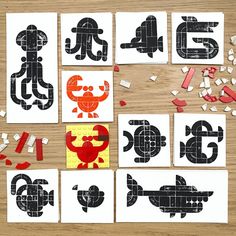 several pieces of paper cut out to look like letters and numbers on a wooden table