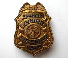 a badge that says anahemi junior fireman cale on it's side