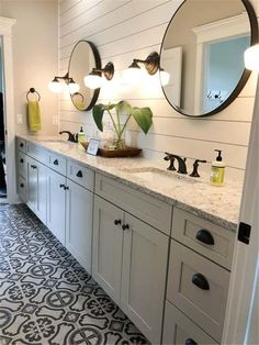 a bathroom with two sinks and three mirrors on the wall next to eachother