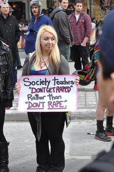 a woman holding a sign that says society heads don't tamed rather than don't race