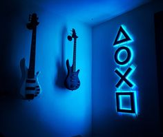 two guitars are lit up against the wall next to a neon sign that says xoxo