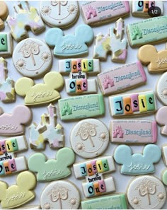 mickey mouse cookies are arranged on a white surface with the words disneyland written in small letters