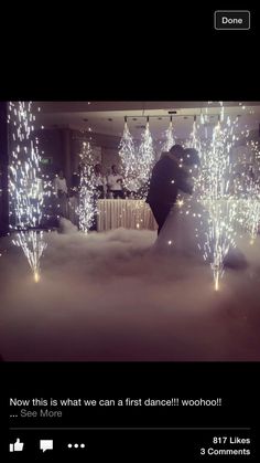 a bride and groom standing in the clouds with sparklers on their wedding gowns