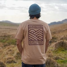 Simplicity meets wilderness meets adventure. The Outback T-Shirt is a perfect reminder of the last time you explored an untamed landscape. Designed for adventure-seekers who love the rolling landscapes that surround us here on Dartmoor and all National Parks around the World.  All our tees are screen printed by us at our hq in Dartmoor National Park.  All our organic cotton t shirts are designed for both men and women. Our nature and outdoor graphics are inspired by the landscapes that surround Men’s Style Graphic Tees, Mens Tee Shirt Designs, Outdoor Cotton T-shirt With Graphic Design, Cotton Graphic Print T-shirt For Outdoor, Unisex Organic Cotton T-shirt With Graphic Print, Relaxed Fit Text Print T-shirt For Outdoor, Custom Print Cotton T-shirt For Adventure, Dartmoor National Park, Shirt Print Design