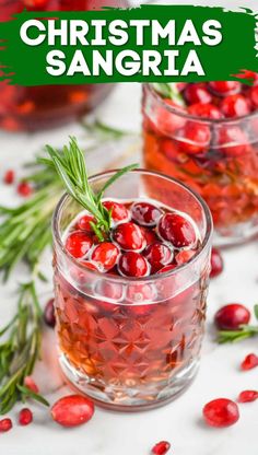 two glasses filled with cranberry christmas sangria and garnished with rosemary