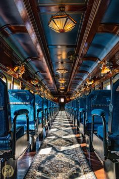 the inside of a bus with blue seats and rugs on the floor, along with lights