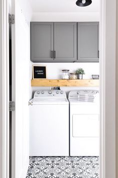 a white washer and dryer sitting inside of a kitchen next to a doorway