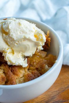 a close up of a bowl of food with ice cream on top and napkins in the background