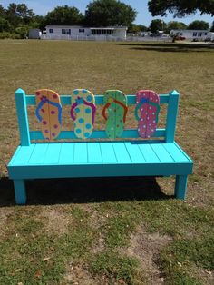 a blue bench with flip flops painted on it