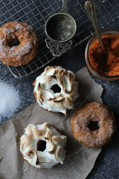 three doughnuts sitting on top of a piece of wax paper