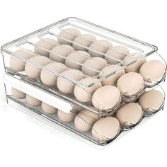 two trays filled with eggs sitting on top of each other in front of a white background