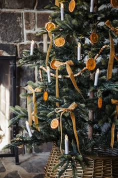 a decorated christmas tree with candles and ribbons