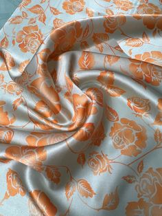 an orange and white floral print fabric