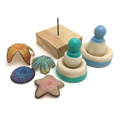 an assortment of carved wooden toys on a white surface, including a rubber stamper