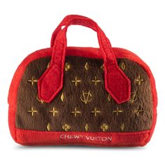 a brown and red handbag with gold crosses on it