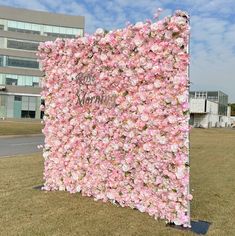 a large pink flowered wall in front of a building